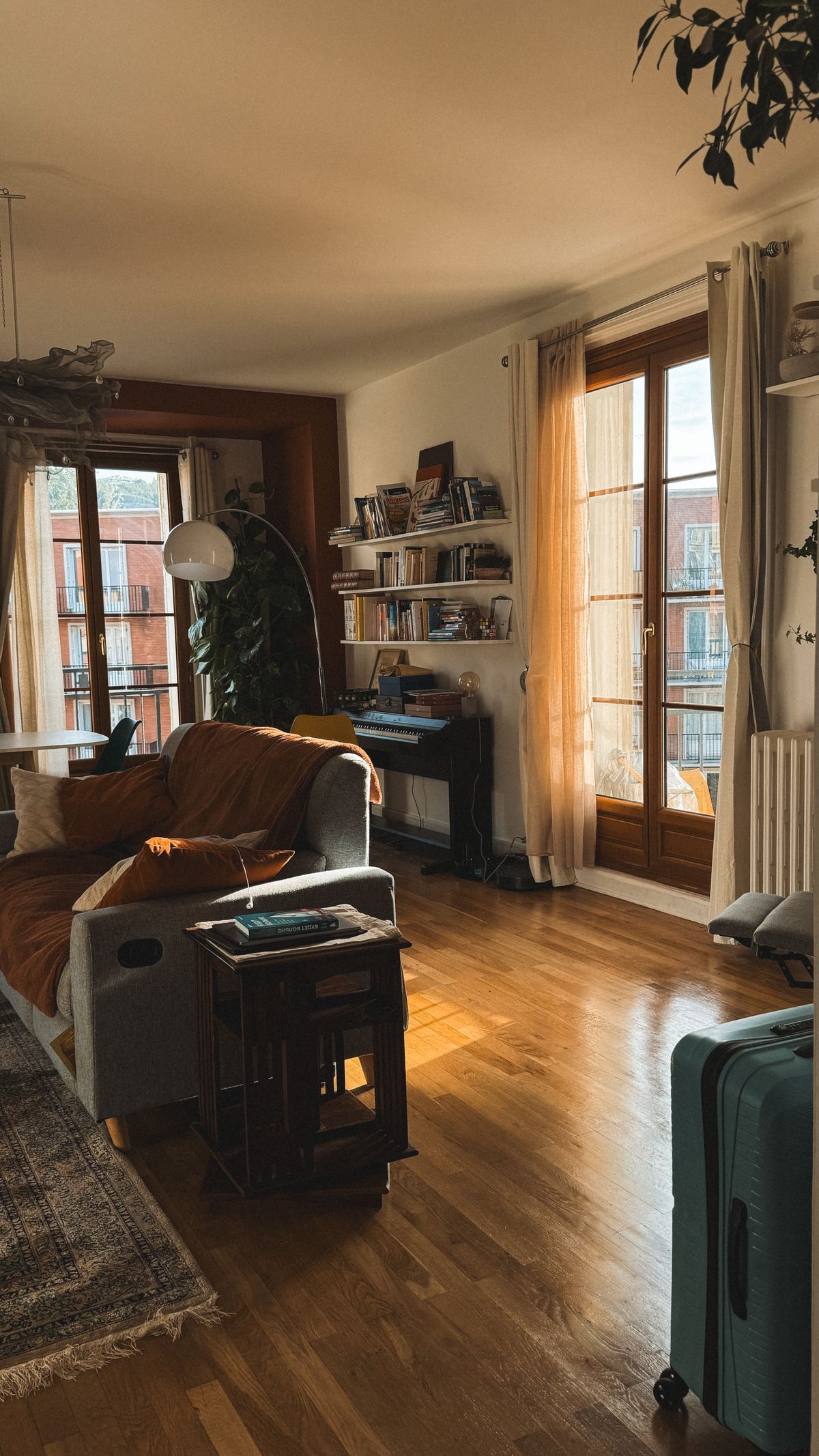 A warm, well-kept living room with wooden floors and natural light